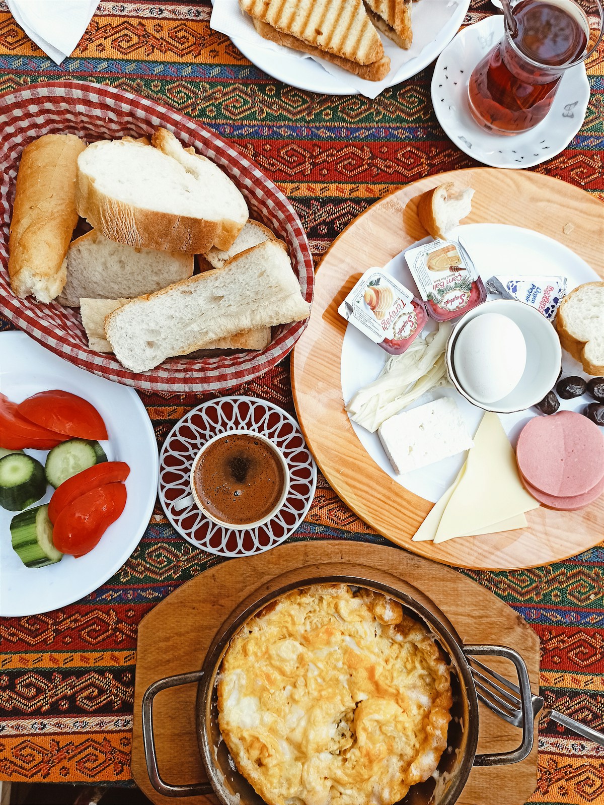 Traditional Turkish breakfast spread on a colourful tablecloth with bread, cheese, pastries and tea — Istanbul, Turkey