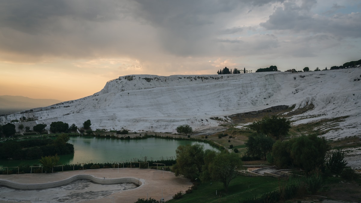 White travertine terraces and thermal pool at Pamukkale with the valley below, Denizli, Turkey