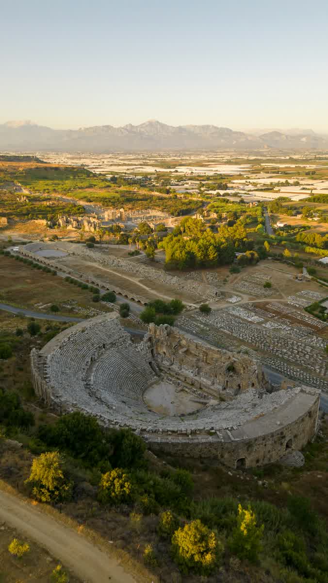 Aerial view of Aspendos Roman theatre at sunrise with Taurus Mountains behind, Antalya province, Turkey