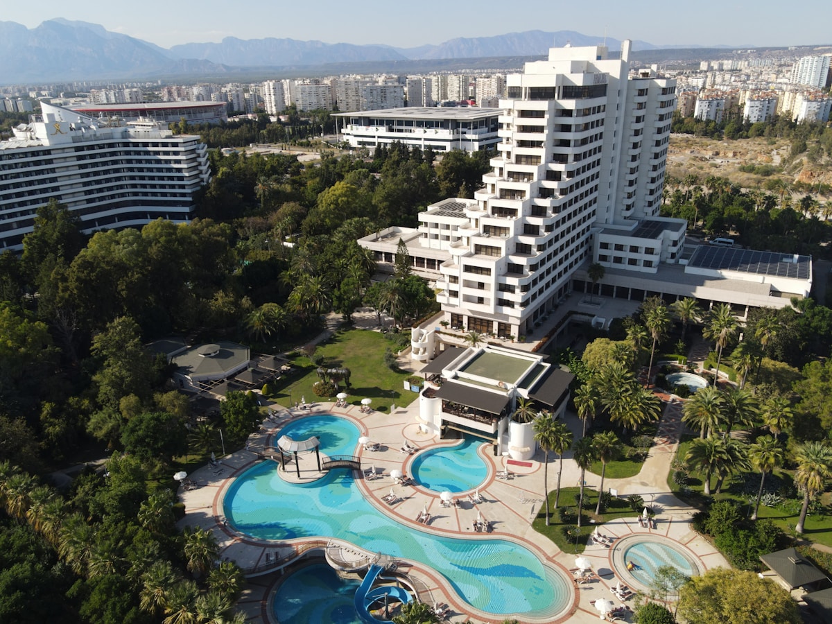Aerial view of a large Turkish hotel complex with pools and gardens in Antalya, Turkey