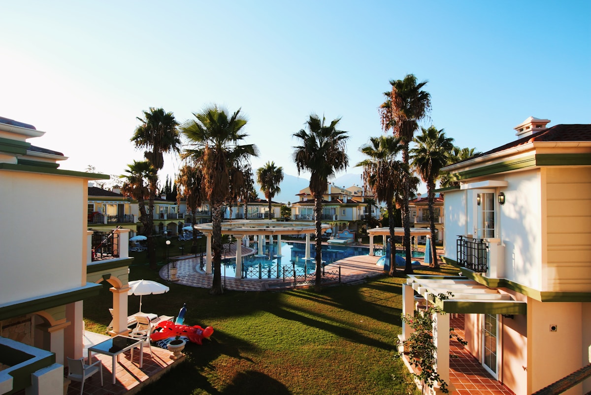 Large resort pool with lounge chairs and palm trees at a hotel near Çeşme, Aegean Turkey