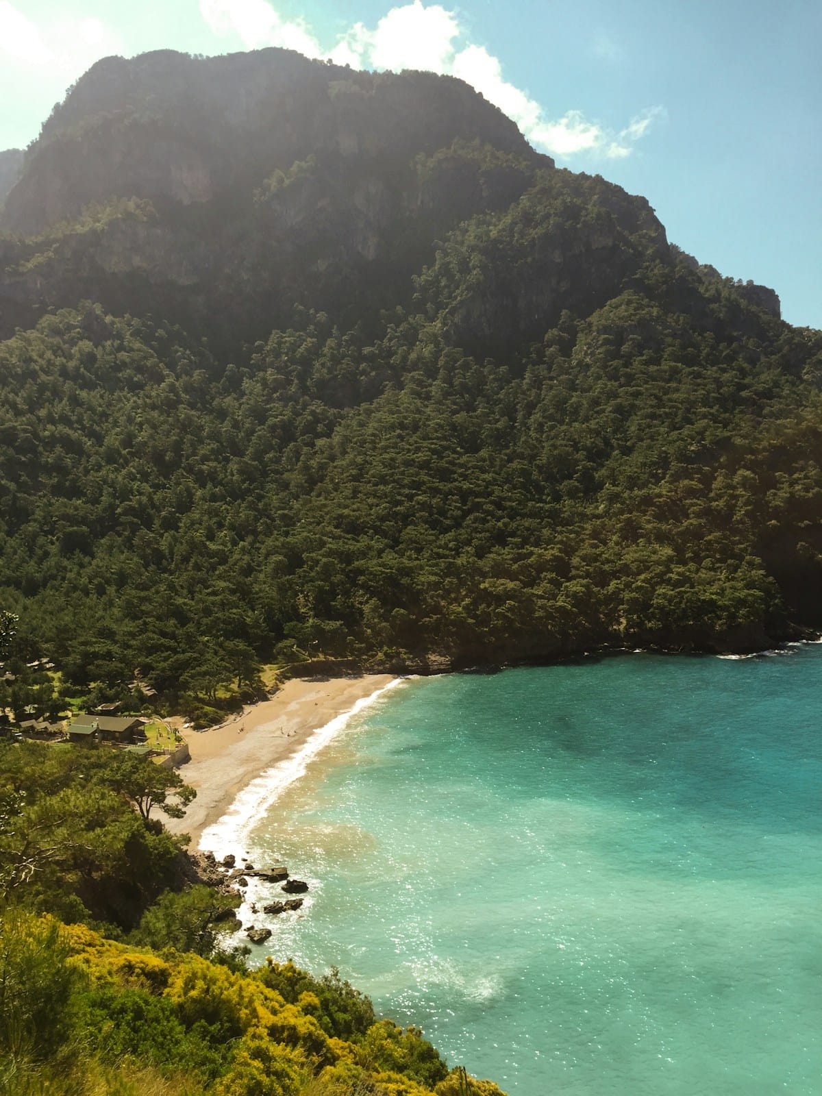 Kabak beach near Fethiye, framed by forested mountains and turquoise water on the Turkish Riviera