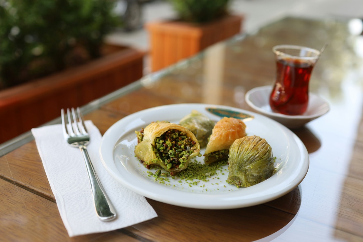 Pistachio baklava and Turkish tea on a white plate