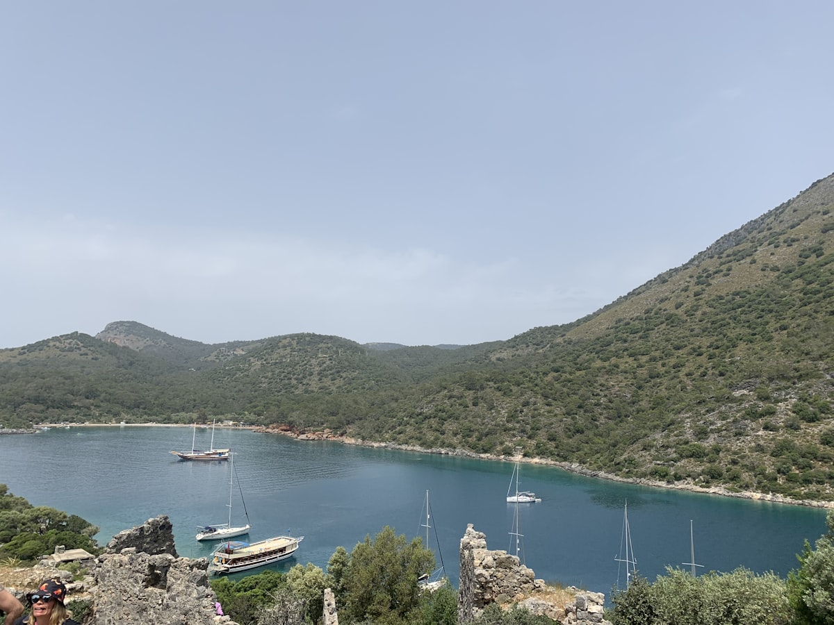 Gulet boat anchored in a sheltered bay surrounded by pine hills near Göcek, Gulf of Fethiye