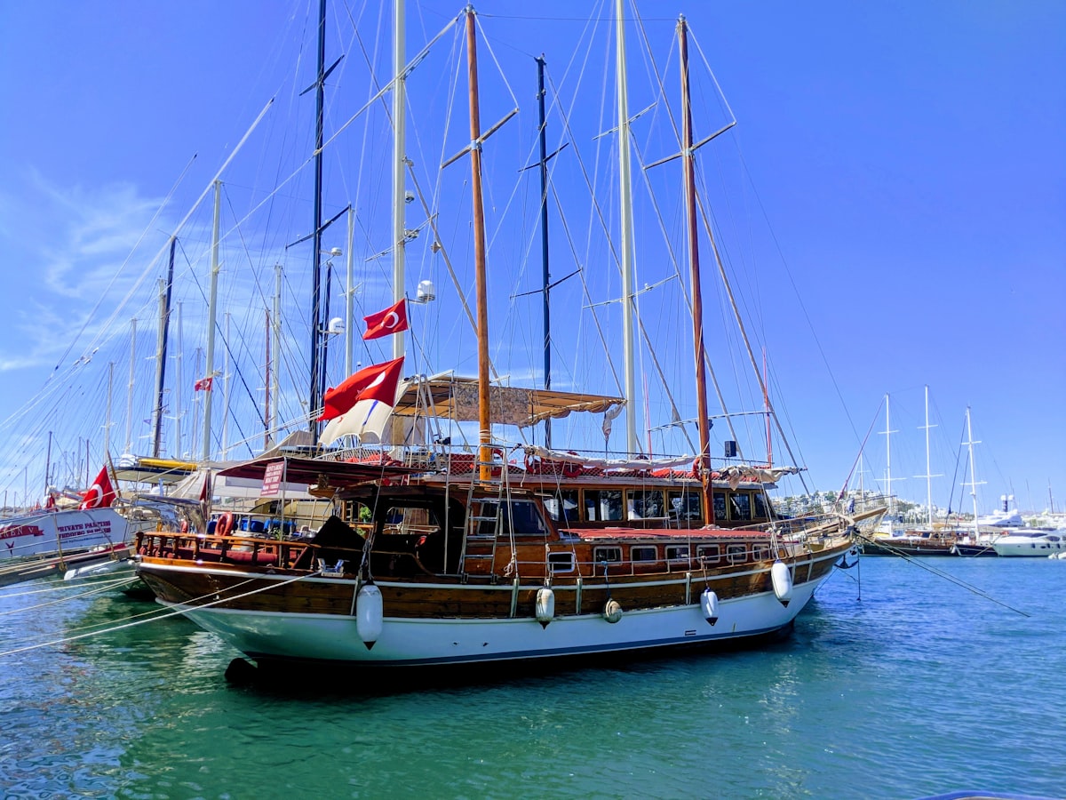 Traditional Turkish gulet moored in Bodrum marina, Turkish flag flying from the mast
