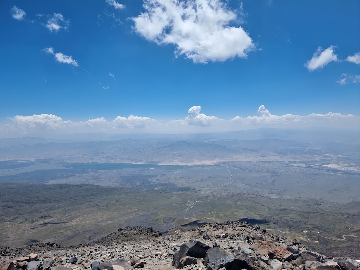 View from high on Mount Ararat looking down at the vast Doğubayazıt plain and the eastern Turkey plateau under a blue sky