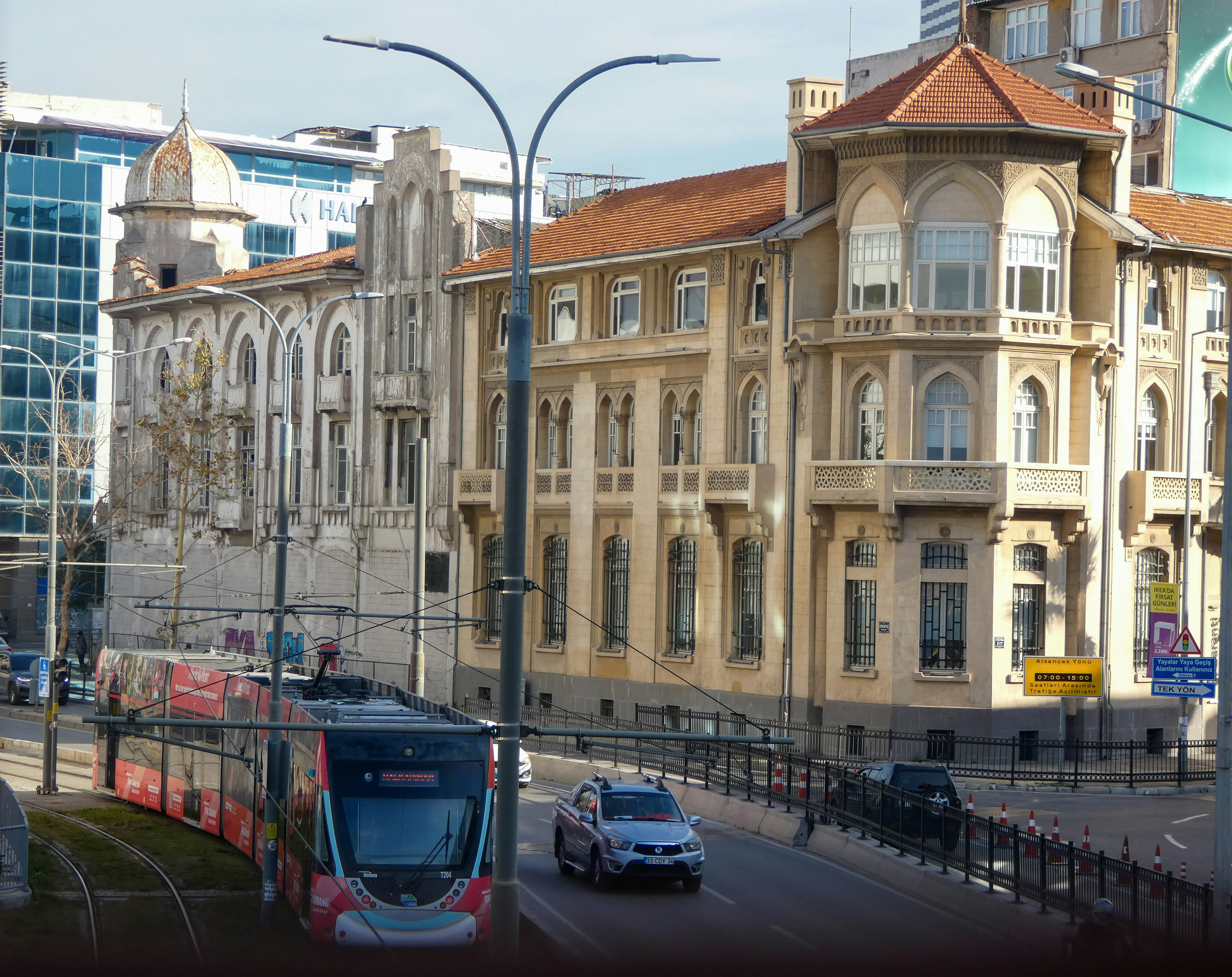 Modern İzmir tram travelling along a central street past historic buildings in İzmir, Turkey