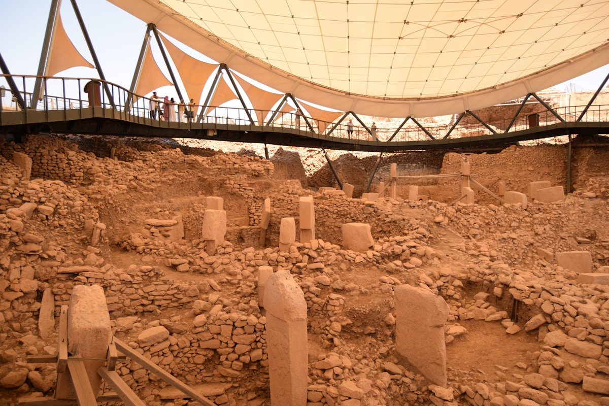 T-shaped limestone pillars inside a circular enclosure under a tensile protective canopy at a Neolithic site in Şanlıurfa province, Turkey