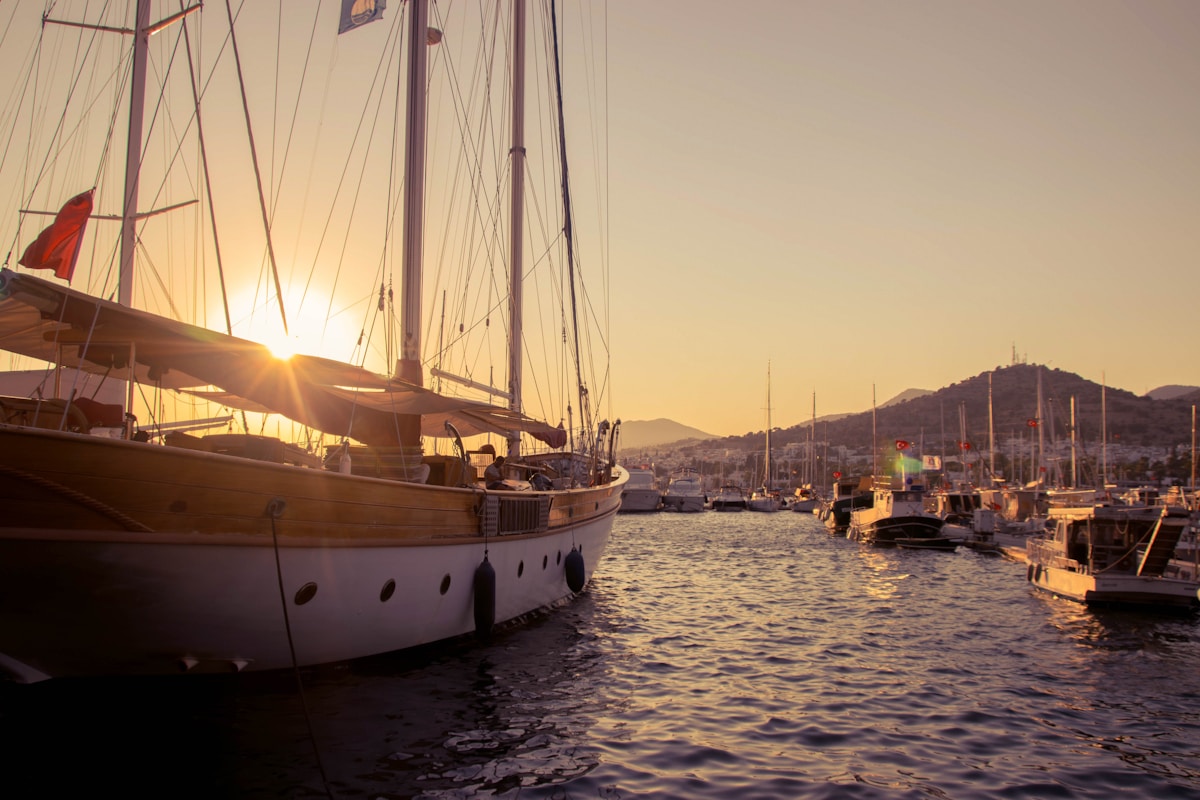 Gulet sailing boats moored in Bodrum marina at sunset, Muğla province, Turkey