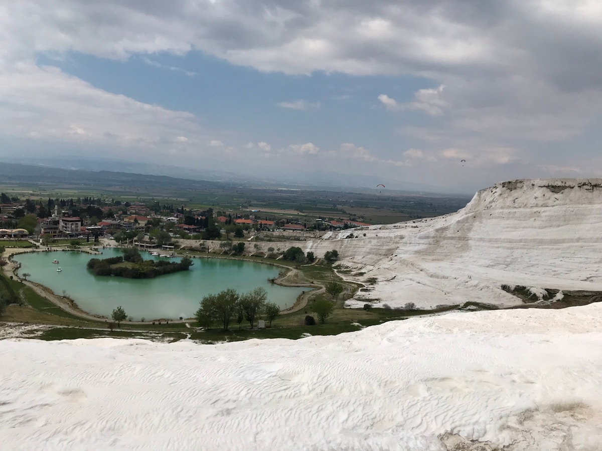 White travertine terraces at Pamukkale with turquoise thermal pool below, Denizli province, Turkey