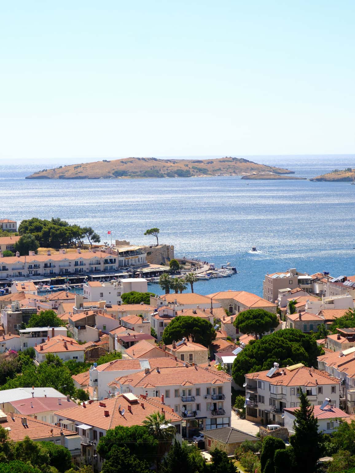 Ferry terminal at Çeşme harbour with the Genoese castle and Aegean sea in the background