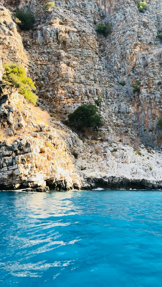 Turquoise water against limestone cliffs on the Lycian coast near Fethiye, Muğla, Turkey