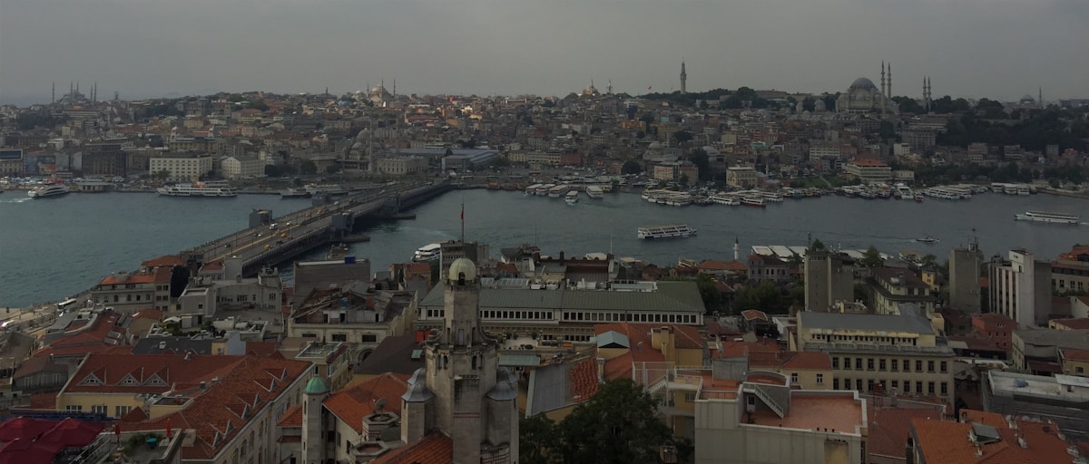 Historic stone gate by the sea in Turkey — flight delay guide
