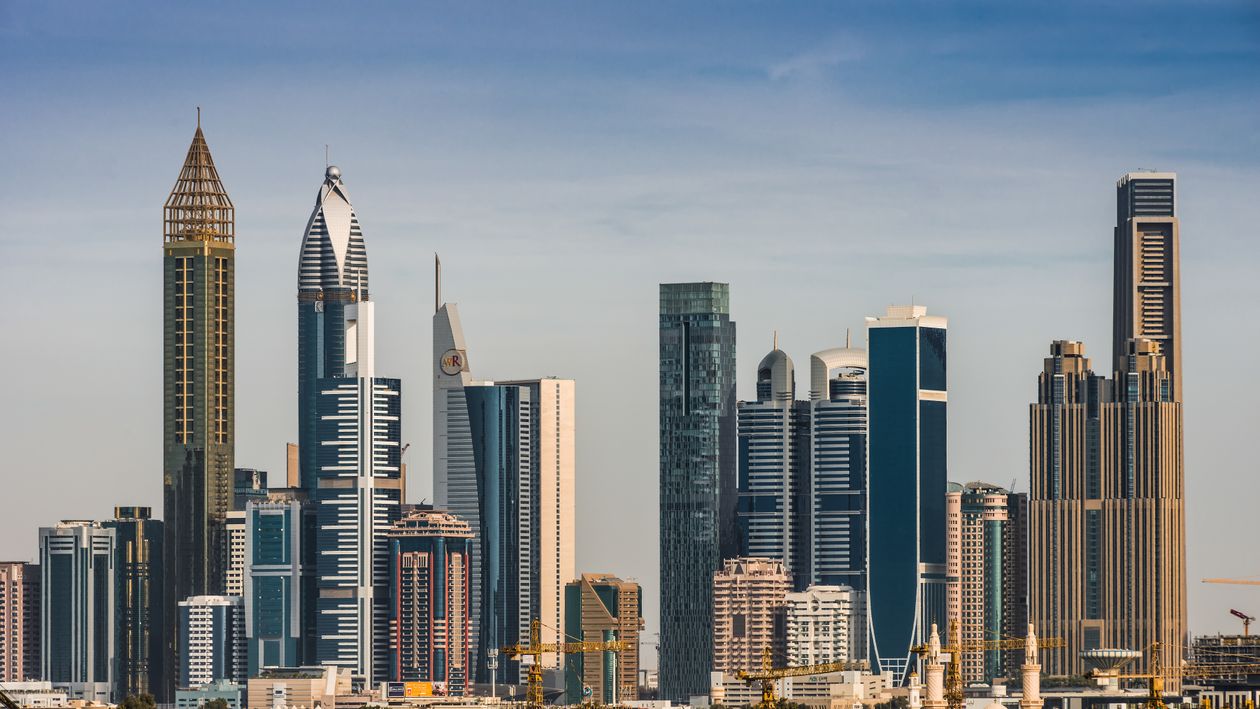 Dubai skyline with modern glass skyscrapers under a clear blue sky, United Arab Emirates