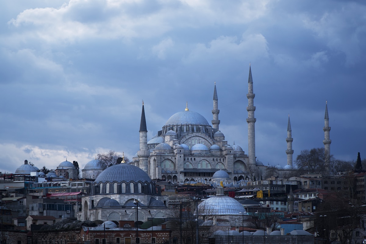 Süleymaniye Mosque domes and minarets dominating the Istanbul skyline under stormy clouds, Turkey