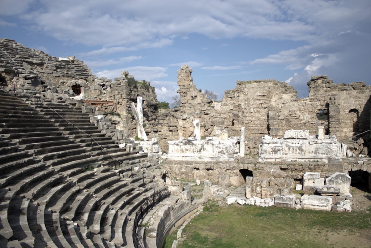 Roman theatre with curved stone seating tiers at the ancient city of Side, Manavgat, Antalya, Turkey