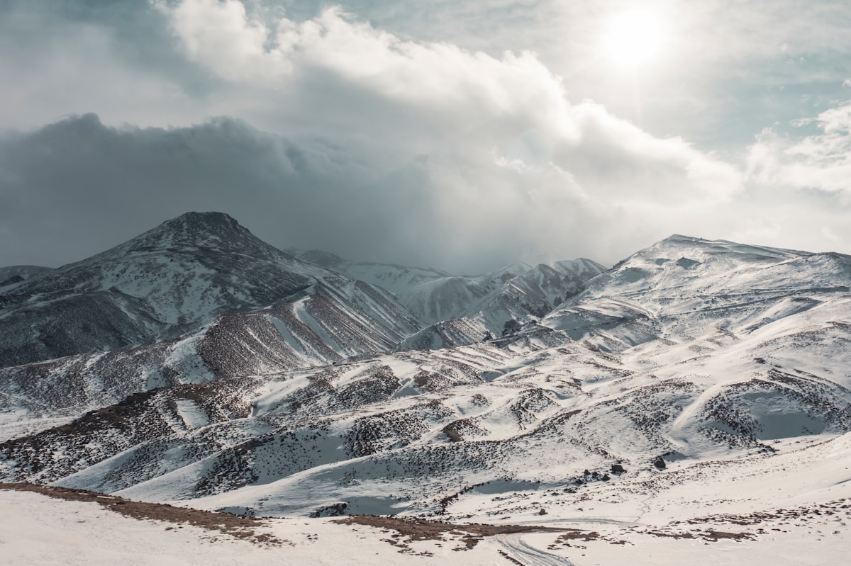 Snow-covered slopes and volcanic cone of Mount Erciyes above Kayseri, central Turkey, under dramatic winter sky