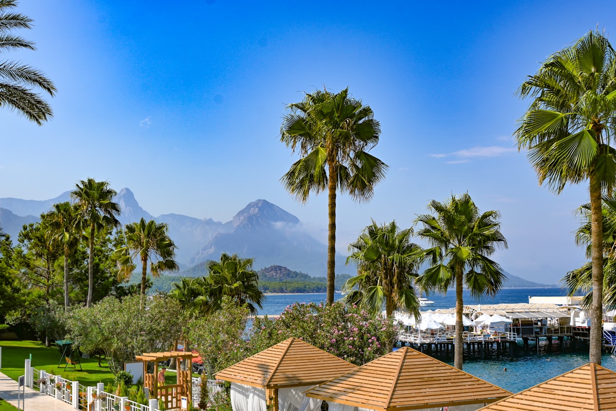 Resort with palm trees and mountain backdrop at Kemer, Antalya, Turkey