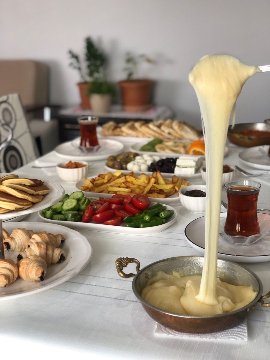 Turkish breakfast table with cheese, vegetables, pastries and tea